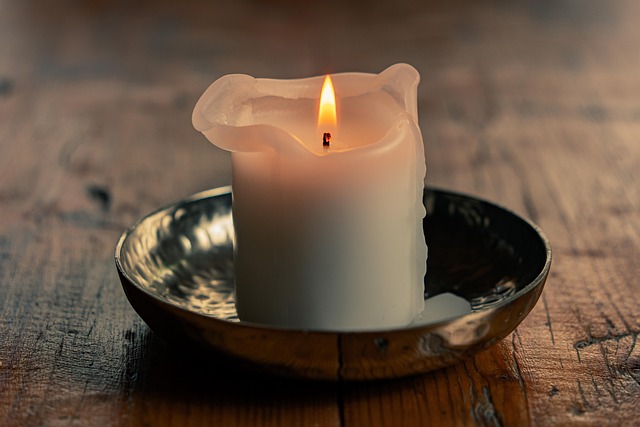 Artisan hand-poured candles in decorative glass vessels and ceramic holders with soft warm glow